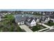 Aerial view of a grey home with lush landscaping and a serene pond at 10297 Anees Ln, Fishers, IN 46040