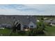 Aerial view showcasing the home's backyard, patio, landscaping, and the surrounding neighborhood with lush greenery at 10297 Anees Ln, Fishers, IN 46040