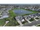 Expansive aerial view of a grey home nestled in a community near a scenic pond at 10297 Anees Ln, Fishers, IN 46040