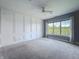 Bedroom featuring designer millwork on the walls, neutral carpet and a large window for natural light at 10297 Anees Ln, Fishers, IN 46040