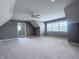 A carpeted bonus room featuring neutral walls, a ceiling fan, and a window with blinds at 10297 Anees Ln, Fishers, IN 46040