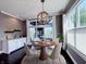Dining room with hardwood floors, a modern chandelier and sliding doors overlooking the backyard at 10297 Anees Ln, Fishers, IN 46040