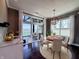 Dining area with hardwood floors, a pendant light fixture and sliding doors overlooking the backyard at 10297 Anees Ln, Fishers, IN 46040