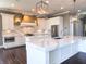 Modern kitchen with white cabinets, marble countertops, and designer lighting at 10297 Anees Ln, Fishers, IN 46040