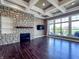 Bright living room with stone fireplace and views of the outdoor patio at 10297 Anees Ln, Fishers, IN 46040