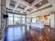 Open-concept living room with hardwood floors, a stone fireplace, and an adjacent kitchen at 10297 Anees Ln, Fishers, IN 46040