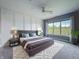 Beautiful primary bedroom with decor wall, fan, plush carpet and sun-filled window at 10297 Anees Ln, Fishers, IN 46040
