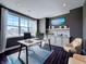 Office featuring large windows, dark walls, hardwood floors, built in shelving, cabinets and modern desk at 10297 Anees Ln, Fishers, IN 46040