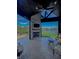 Outdoor patio with fireplace, TV, ceiling fan, and scenic lake views, perfect for relaxation and entertainment at 10297 Anees Ln, Fishers, IN 46040