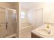 Bright bathroom with double sinks, walk-in shower, and soaking tub at 11005 Long Lake Ln, Fishers, IN 46037