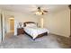 Bedroom features a queen bed, ceiling fan, bedside tables, and ensuite access at 11005 Long Lake Ln, Fishers, IN 46037