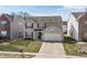 Charming two-story home with a brick facade, red shutters, and a well-manicured lawn at 11005 Long Lake Ln, Fishers, IN 46037