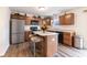 Modern kitchen with stainless steel appliances, a center island with seating, and plenty of counter space at 11005 Long Lake Ln, Fishers, IN 46037