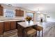 The kitchen has wood cabinets, stainless steel appliances, an eat-in island and hard surface floors at 11005 Long Lake Ln, Fishers, IN 46037