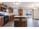 An eat-in kitchen features stainless steel appliances, wood cabinets, and an island with stool seating at 11005 Long Lake Ln, Fishers, IN 46037