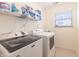 Well-organized laundry room features modern washer, dryer, and storage shelving at 11005 Long Lake Ln, Fishers, IN 46037
