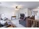 A living room features plush carpeting, a ceiling fan and a large television set at 11005 Long Lake Ln, Fishers, IN 46037