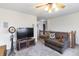 This living room has plush carpet, a ceiling fan and a television set on display at 11005 Long Lake Ln, Fishers, IN 46037