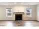 Bright living room featuring a fireplace, hardwood floors, and plenty of natural light at 11005 Long Lake Ln, Fishers, IN 46037