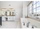 Beautiful bathroom with a soaking tub, granite counters, double vanity, and bright natural lighting at 11727 Windpointe Pass, Carmel, IN 46033