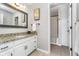 Bathroom features a granite countertop, white vanity, framed mirror, and a shower/tub combo at 11727 Windpointe Pass, Carmel, IN 46033