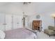 Bedroom showcasing neutral carpet, white walls, and a vintage desk beneath a ceiling fan at 11727 Windpointe Pass, Carmel, IN 46033