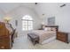 Vaulted ceiling bedroom features a window, desk, queen bed, and neutral toned walls at 11727 Windpointe Pass, Carmel, IN 46033