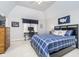 Cozy bedroom featuring a vaulted ceiling, a blue plaid bedspread, and a dedicated workspace for work at 11727 Windpointe Pass, Carmel, IN 46033