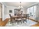Elegant dining room with hardwood floors, a chandelier, and a large window with curtains at 11727 Windpointe Pass, Carmel, IN 46033