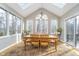 Bright dining room featuring large windows, a chandelier and access to the outdoor deck at 11727 Windpointe Pass, Carmel, IN 46033