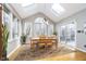 Bright dining room with vaulted ceiling, skylights, and sliding door access to a deck at 11727 Windpointe Pass, Carmel, IN 46033