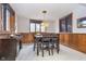 Basement dining room with wood paneling, a dark wood table with seating for four, and a pendant light at 11727 Windpointe Pass, Carmel, IN 46033