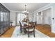 Spacious dining room featuring hardwood floors, decorative lighting, and large windows at 11727 Windpointe Pass, Carmel, IN 46033