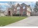 Well-maintained home with manicured lawn, mature trees, and a long driveway leading to an attached garage at 11727 Windpointe Pass, Carmel, IN 46033