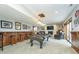 Basement game room features a pool table, bar, and brick fireplace with a mounted TV at 11727 Windpointe Pass, Carmel, IN 46033