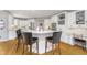 Well-lit kitchen features a white center island with breakfast bar and stylish black leather counter stools at 11727 Windpointe Pass, Carmel, IN 46033