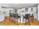 Bright kitchen features white cabinets, stainless steel appliances, and a large island with seating at 11727 Windpointe Pass, Carmel, IN 46033