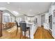 Bright kitchen features hardwood floors, a skylight, a white island with seating, and stainless steel appliances at 11727 Windpointe Pass, Carmel, IN 46033