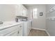 Functional laundry room featuring a utility sink and modern washer and dryer units at 11727 Windpointe Pass, Carmel, IN 46033