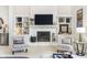 Cozy living room boasts a white brick fireplace with mantle, built-in shelving, and comfortable seating at 11727 Windpointe Pass, Carmel, IN 46033