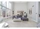Spacious living room with soaring ceilings, large windows, and a comfortable sectional sofa for relaxing at 11727 Windpointe Pass, Carmel, IN 46033