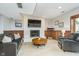 Carpeted basement living room with wood trim, brick fireplace, and access to back patio at 11727 Windpointe Pass, Carmel, IN 46033