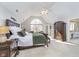 Spacious main bedroom with a ceiling fan, king bed and a large window view at 11727 Windpointe Pass, Carmel, IN 46033