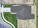 A bird's eye view of the home showing the roof, driveway, sidewalk, and surrounding green space at 1202 Brightwood Cir, Greenfield, IN 46140