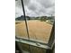 View of newly seeded backyard from a window, showcasing the home's outdoor space at 1202 Brightwood Cir, Greenfield, IN 46140