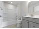 Modern bathroom featuring a shower-tub combination with a gray vanity and stylish fixtures at 1202 Brightwood Cir, Greenfield, IN 46140