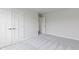Bedroom showcasing neutral walls, carpet, white trim, and doors leading to the rest of the home at 1202 Brightwood Cir, Greenfield, IN 46140