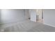 Bright bedroom showcasing neutral carpet, white trim, and multiple doorways enhancing the open feel at 1202 Brightwood Cir, Greenfield, IN 46140