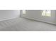 Spacious bedroom with neutral carpeting, white trim, and two windows offering natural light at 1202 Brightwood Cir, Greenfield, IN 46140
