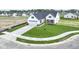 Aerial view of a home featuring a white facade, a two-car garage, a manicured lawn and landscaping at 1202 Brightwood Cir, Greenfield, IN 46140